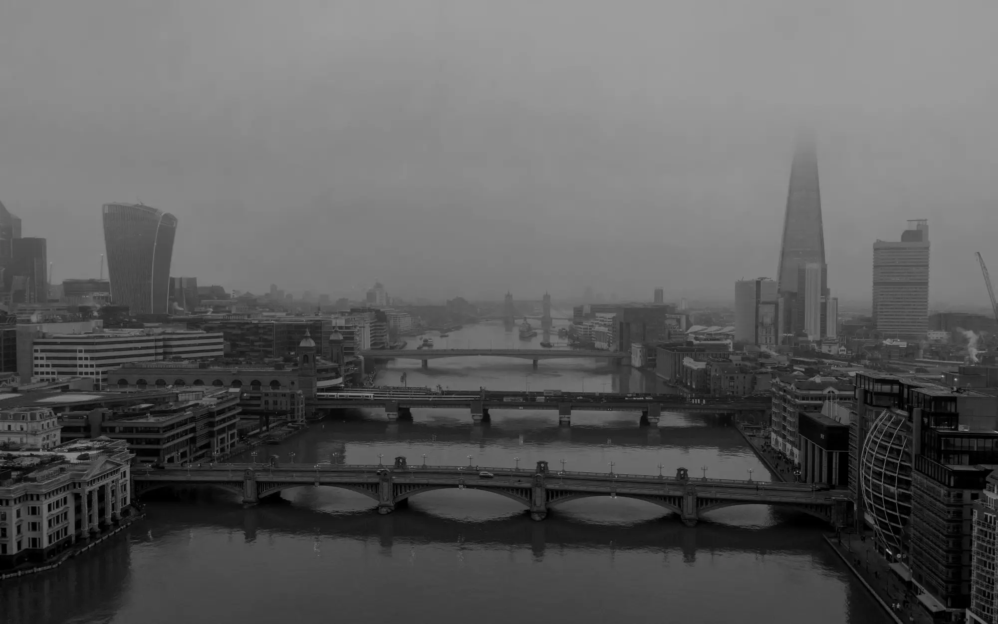 The Thames in fog with its bridges