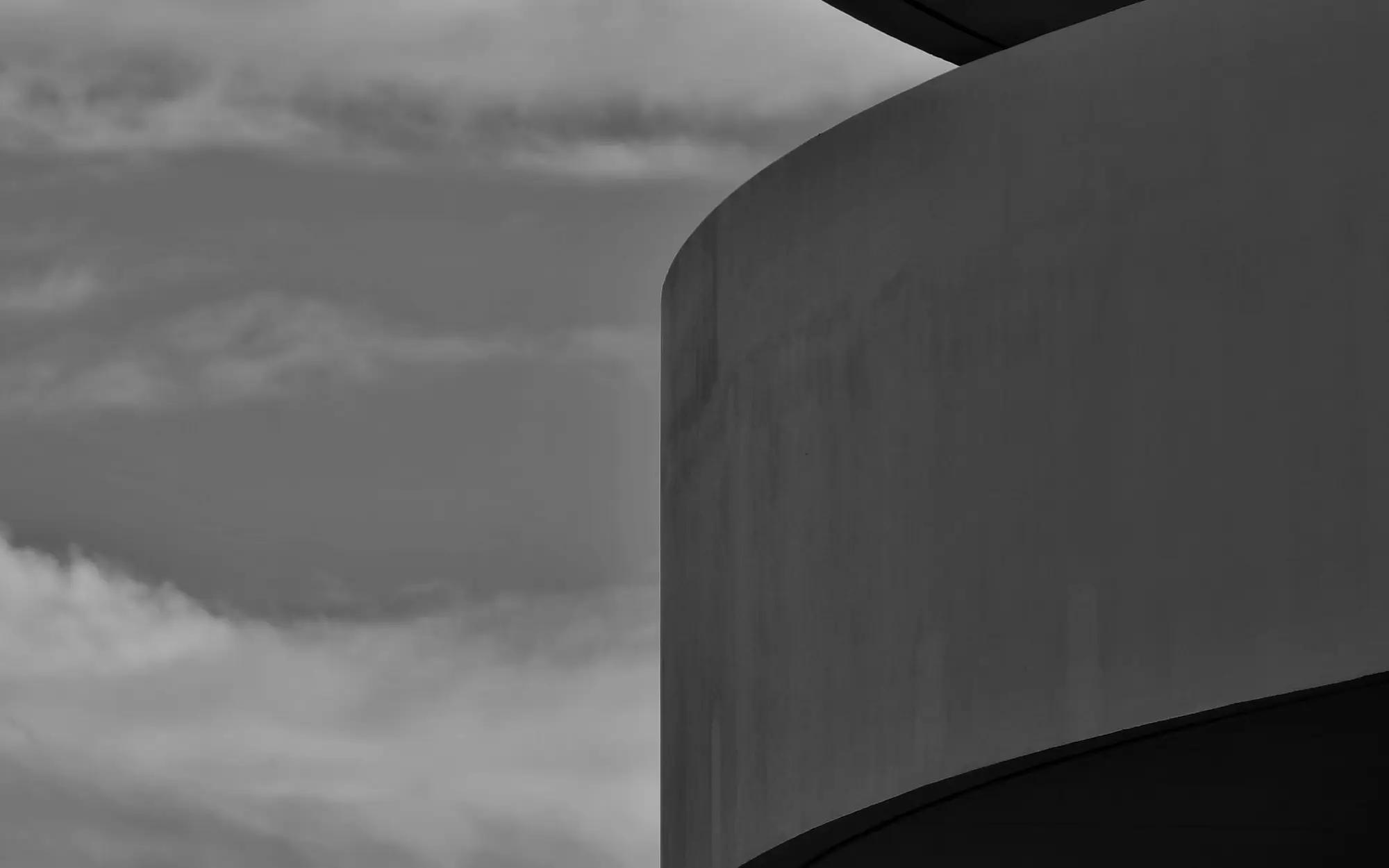 Concrete parking structure against a clouded sky